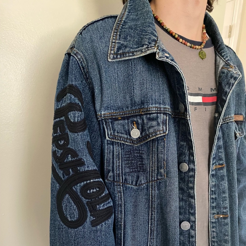 Coca-Cola denim jacket and vans shoes.